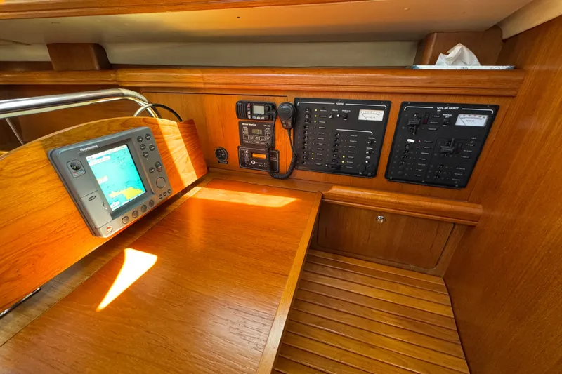 Navigation station of 2004 Hunter 41 Aft Cockpit yacht with control panels and GPS.