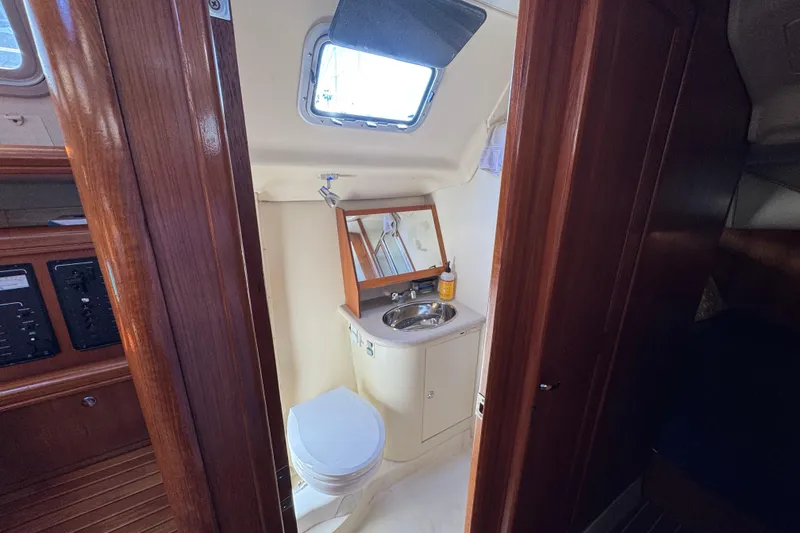 Interior of 2004 Hunter 41 Aft Cockpit yacht bathroom with sink and toilet.