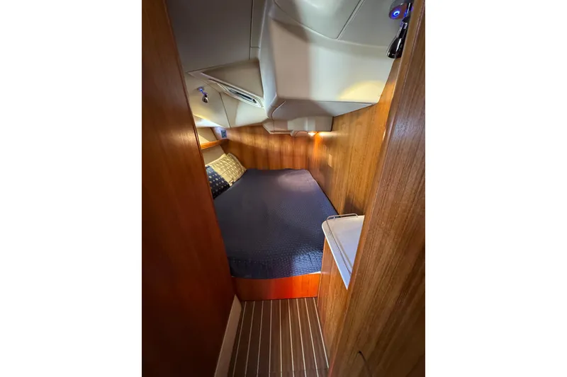 Cozy cabin interior of 2004 Hunter 41 Aft Cockpit sailboat with wooden paneling.