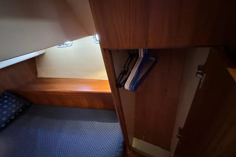 Interior of 2004 Hunter 41 Aft Cockpit yacht with bed and closet.