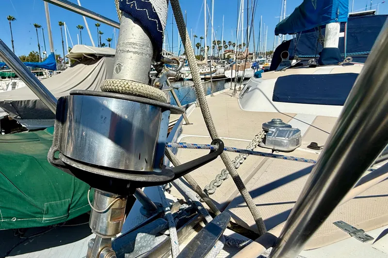 Close-up of a 1988 Catalina 34 sailboat deck with rigging and marina background.