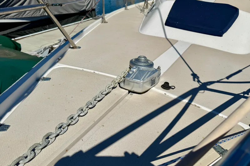 Deck of 1988 Catalina 34 sailboat with anchor chain and winch.