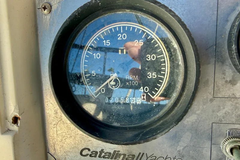 Close-up of a 1988 Catalina 34 yacht tachometer showing RPM and engine hours.