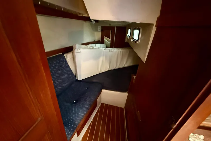 Interior cabin of a 1988 Catalina 34 sailboat with seating and windows.