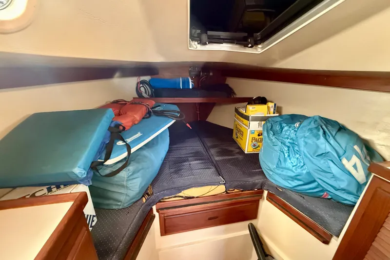 Interior cabin of a 1988 Catalina 34 sailboat with storage items.