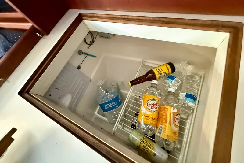 Beverages stored in a Catalina 34 sailboat's built-in cooler, including tonic water and bottled water.