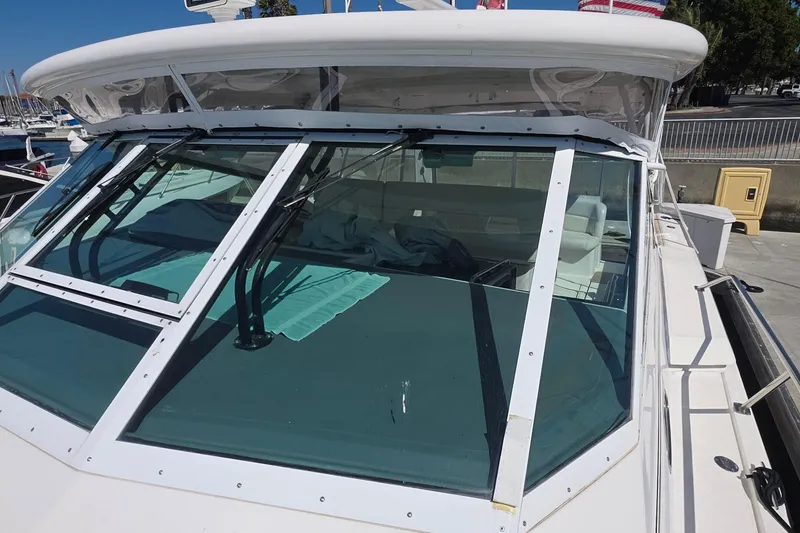 2004 Tiara Yachts 4000 Express boat with clear windshield and docked at marina.