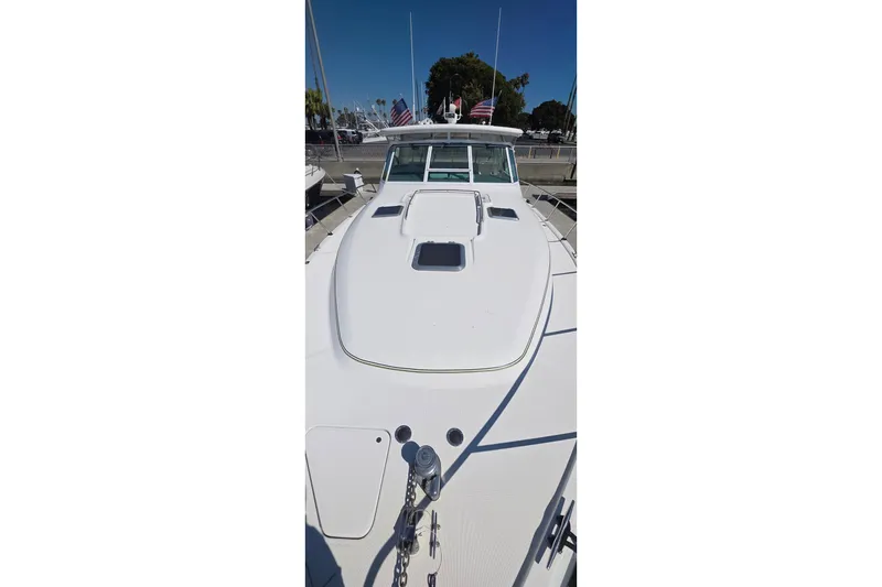 2004 Tiara Yachts 4000 Express boat docked, showcasing sleek white deck design.