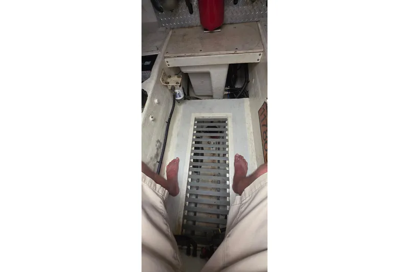 Interior view of a 2004 Tiara Yachts 4000 Express engine room with visible grating.