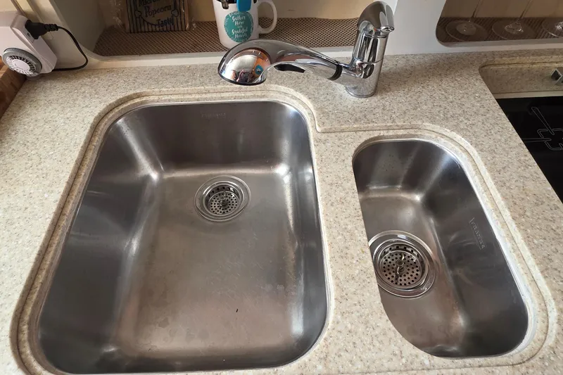 Dual stainless steel sinks in a 2004 Tiara Yachts 4000 Express kitchen.