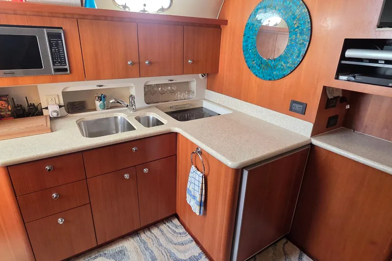 2004 Tiara Yachts 4000 Express kitchen with wood cabinetry and modern appliances.