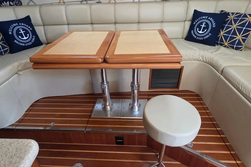 Interior of 2004 Tiara Yachts 4000 Express with elegant seating and wooden table.