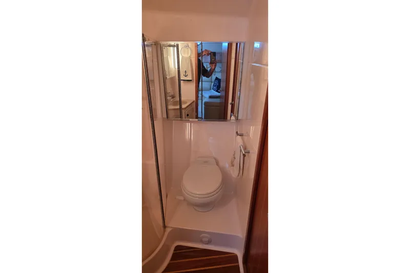 Bathroom interior of 2004 Tiara Yachts 4000 Express with mirror and toilet.
