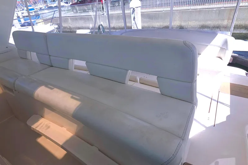 2004 Tiara Yachts 4000 Express interior seating, featuring white cushioned benches.