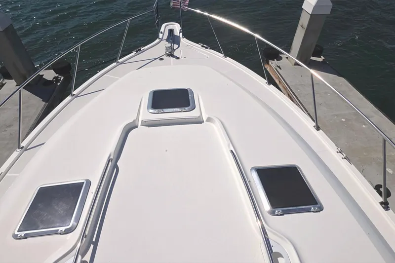 Bow view of 2004 Tiara Yachts 4000 Express docked by the water.