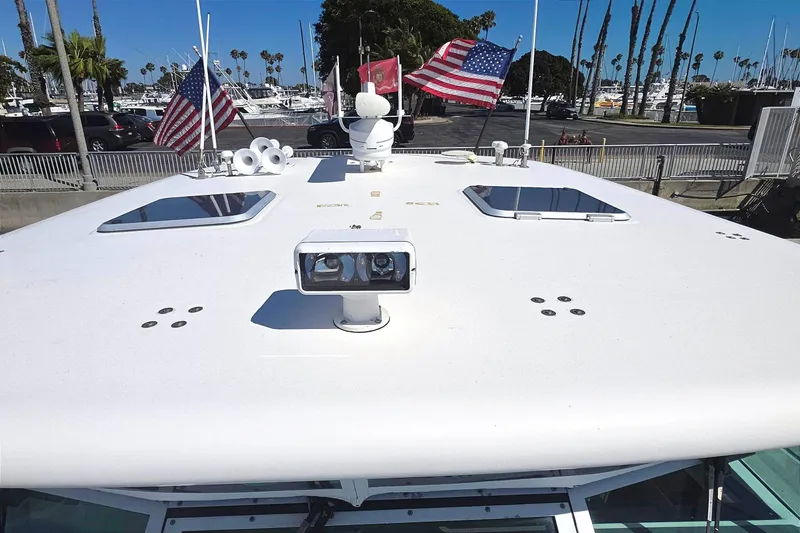 2004 Tiara Yachts 4000 Express boat roof with flags and equipment in marina setting.