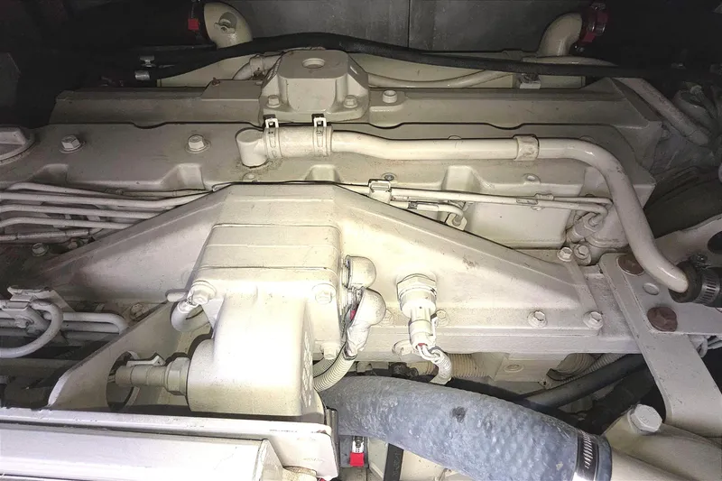 Engine compartment of a 2004 Tiara Yachts 4000 Express, showcasing mechanical components and hoses.