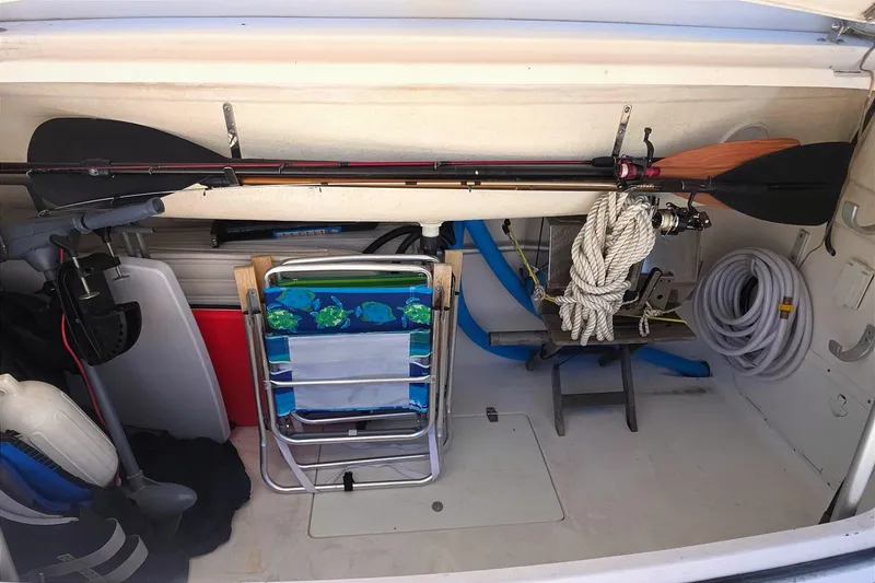Storage compartment of a 2004 Tiara Yachts 4000 Express with fishing gear and boating equipment.