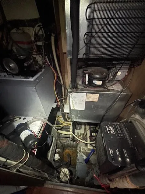 Engine room of 1981 Endeavour 43 Center Cockpit Ketch with visible machinery and wiring.