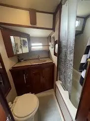 1981 Endeavour 43 Center Cockpit Ketch bathroom with wood cabinetry and shower.