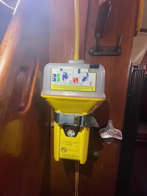 Yellow emergency device on 1981 Endeavour 43 Center Cockpit Ketch interior wooden panel.