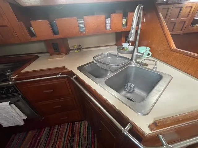 1981 Endeavour 43 Center Cockpit Ketch galley with double sink and wooden cabinetry.