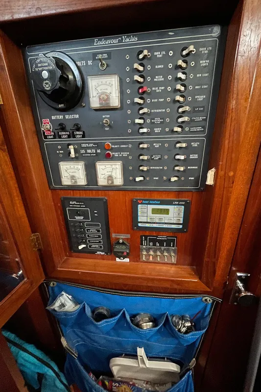 Electrical panel of 1981 Endeavour 43 Center Cockpit Ketch with storage pockets below.