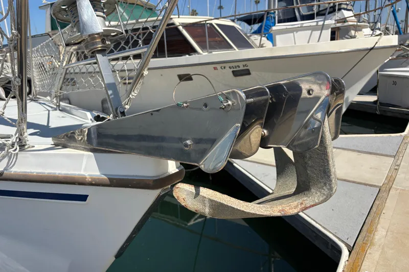 Bow of 1990 Catalina 42 sailboat with anchor and chain at marina.