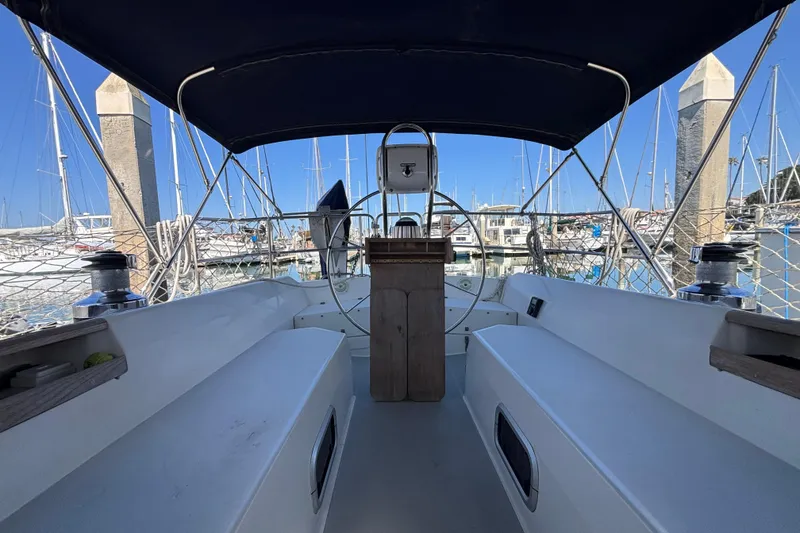 Cockpit view of a 1990 Catalina 42 sailboat docked in a marina.