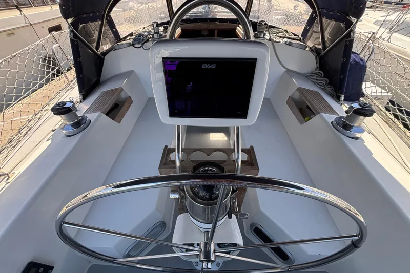 Cockpit of 1990 Catalina 42 sailboat with steering wheel and navigation equipment.