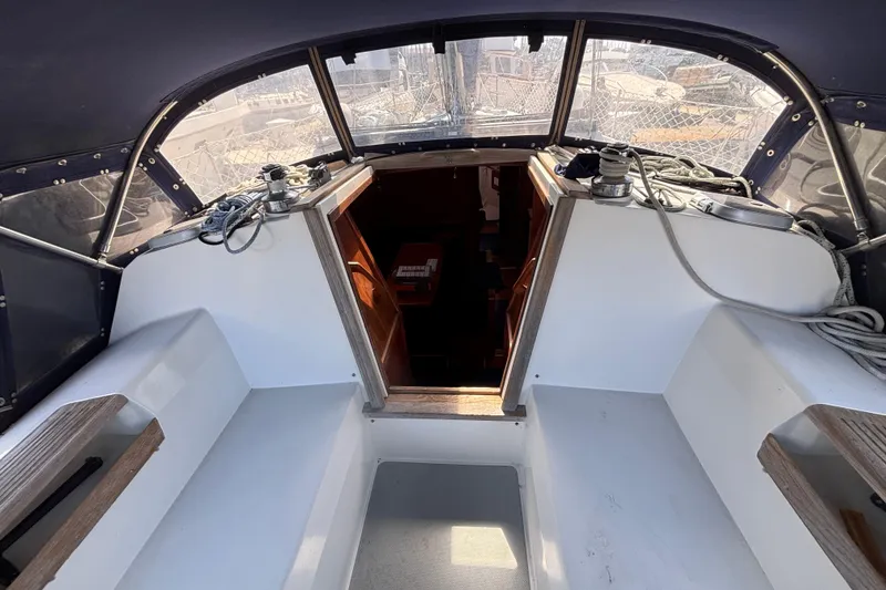 Cockpit of a 1990 Catalina 42 sailboat with ropes and winches.