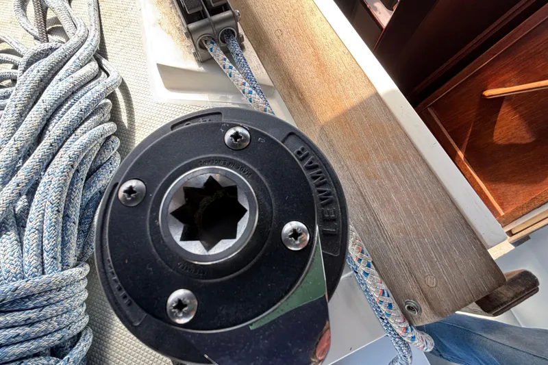 Close-up of a Lewmar winch and rope on a 1990 Catalina 42 sailboat deck.