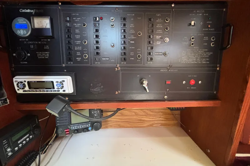 Control panel of a 1990 Catalina 42 yacht with various switches and meters.
