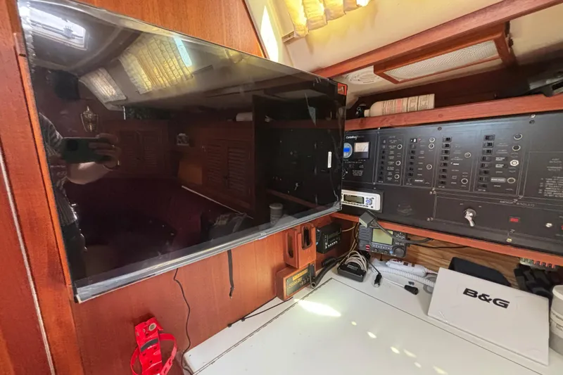 Interior of a 1990 Catalina 42 sailboat with navigation equipment and control panel.