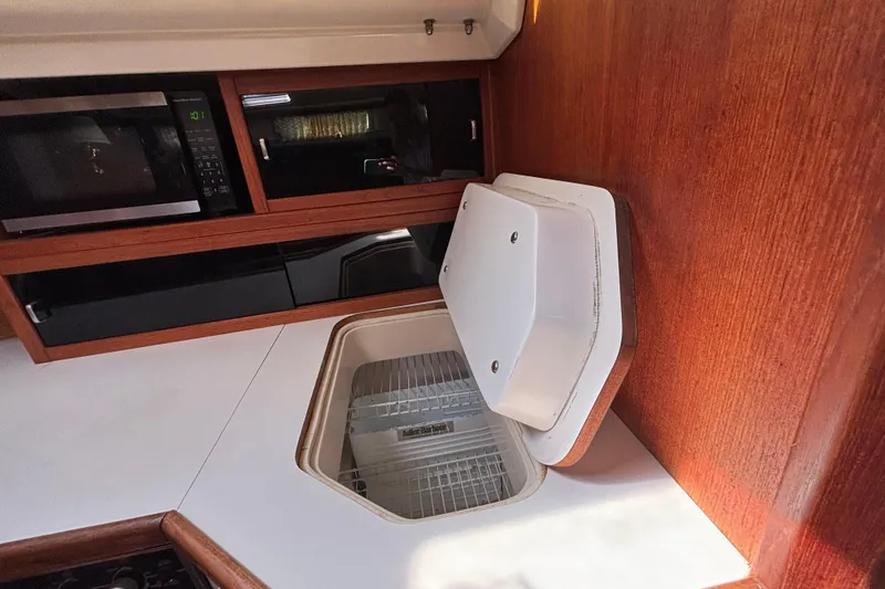 Interior of 1990 Catalina 42 yacht kitchen with microwave and storage.