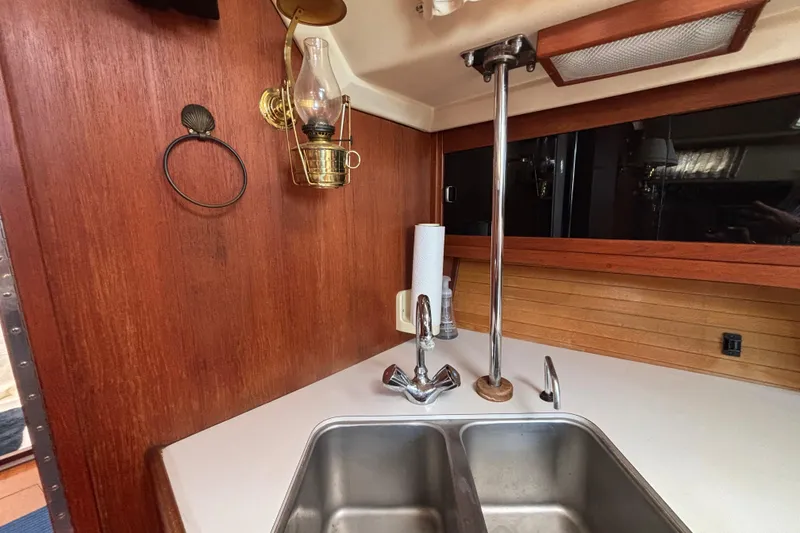 Galley of 1990 Catalina 42 sailboat with double sink and brass lantern.