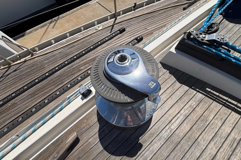 Winch on deck of 1994 Nautor Swan 46 MK II sailboat, featuring teak wood finish.