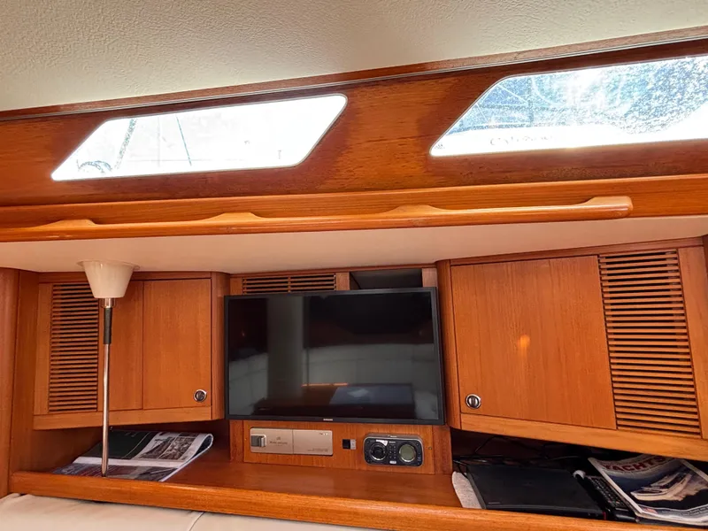 Interior of 1994 Nautor Swan 46 MK II yacht with wooden cabinets and a TV.