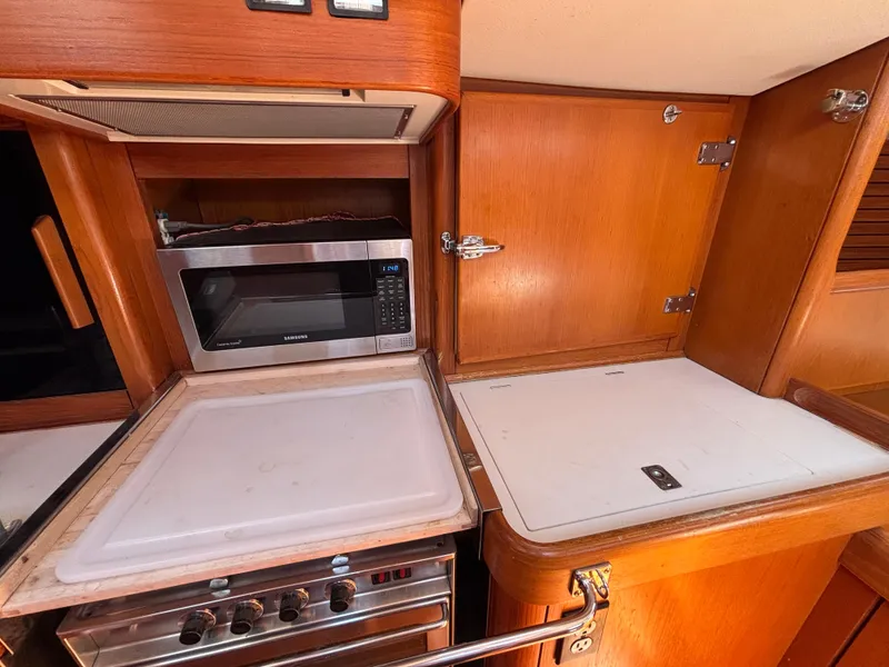 Interior of 1994 Nautor Swan 46 MK II yacht kitchen with microwave and stove.