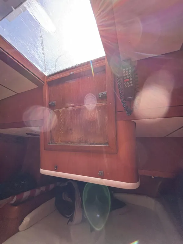 Interior view of 1994 Nautor Swan 46 MK II sailboat with sunlight streaming through hatch.