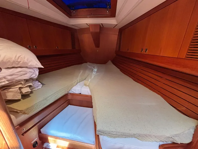 Cozy cabin interior of 1994 Nautor Swan 46 MK II yacht with wooden finish.