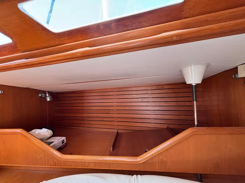 Interior cabin of 1994 Nautor Swan 46 MK II yacht with wooden finish and lighting.