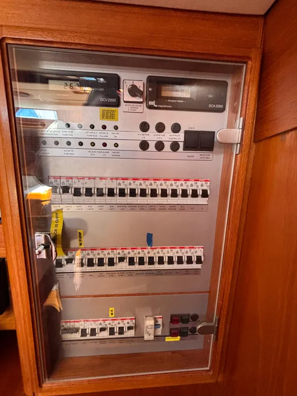 Electrical panel inside a 1994 Nautor Swan 46 MK II yacht, featuring multiple switches and controls.