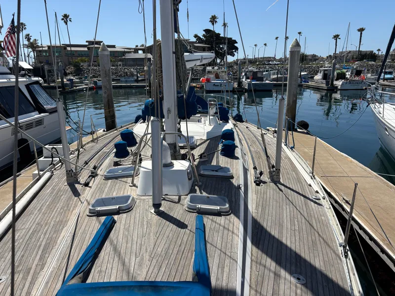 Sailboat Nautor Swan 46 MK II, 1994, docked in a marina with clear skies.