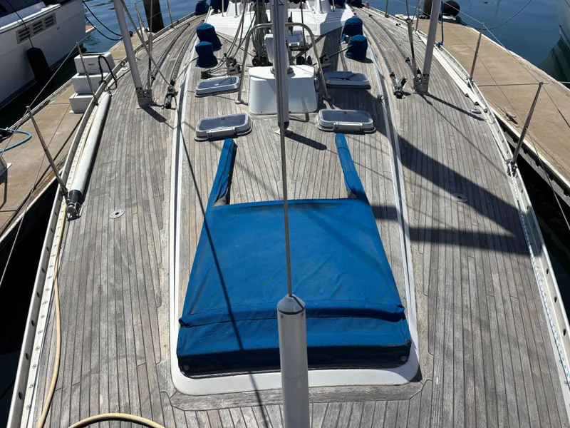 Deck of 1994 Nautor Swan 46 MK II sailboat with blue covers and wooden finish.