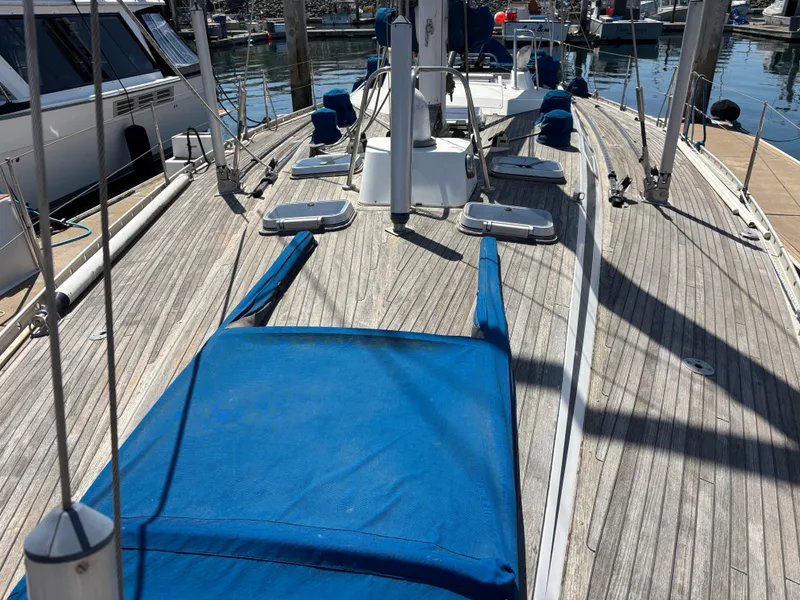 Nautor Swan 46 MK II sailboat deck, 1994 model, with blue covers and wooden finish.