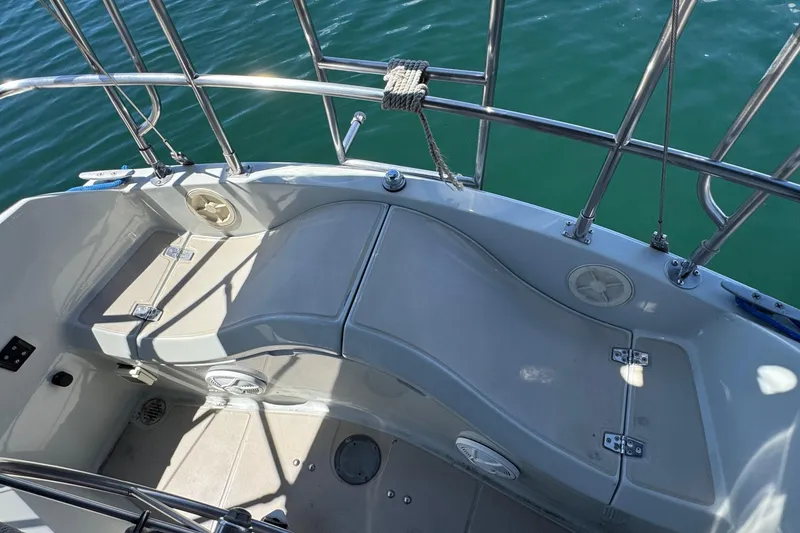 Cockpit of 1989 Ericson Sloop sailboat with seating and stainless steel railings.