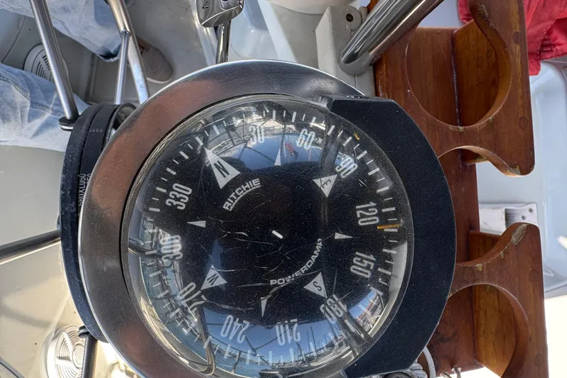 Compass on 1989 Ericson Sloop sailboat, showing navigation directions.