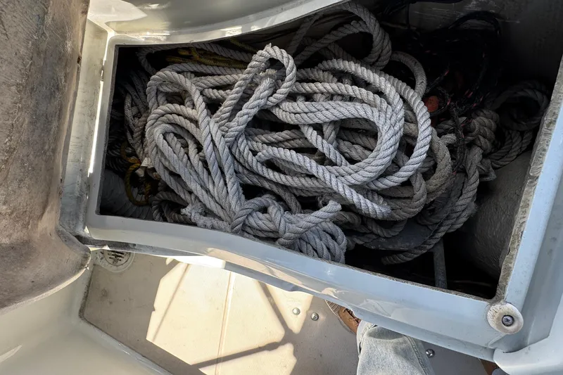 Coiled ropes in storage compartment of 1989 Ericson Sloop sailboat.