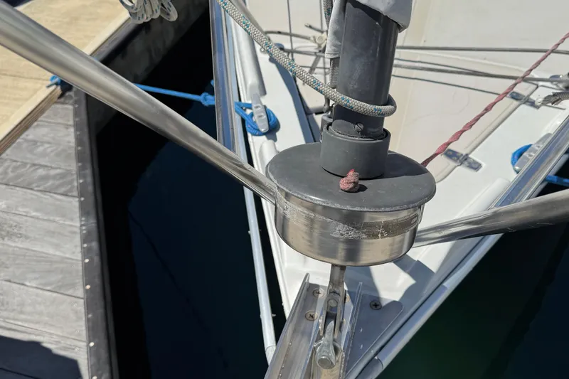 Close-up of 1989 Ericson Sloop's deck hardware and rigging at a marina.